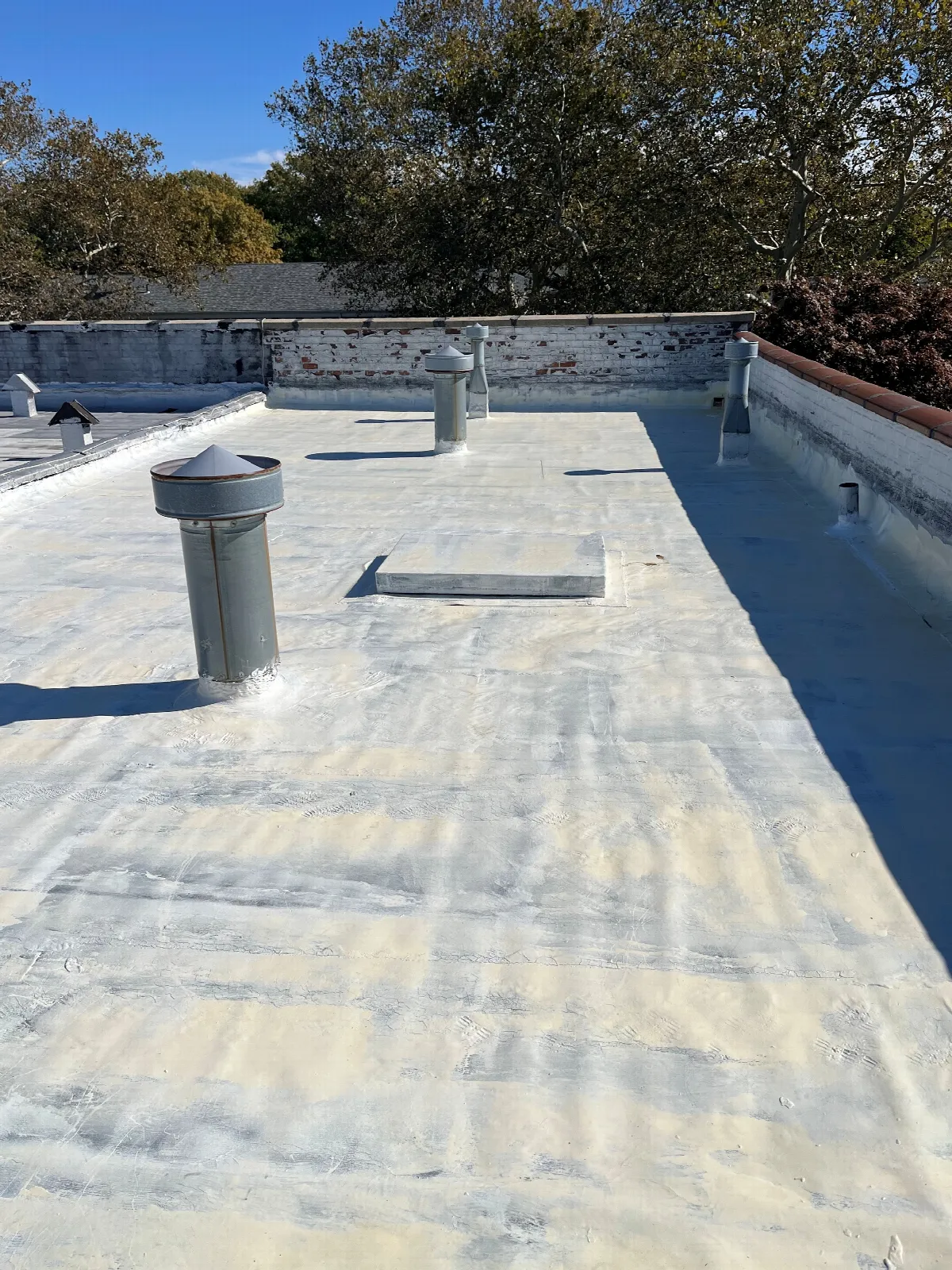 Before: failed elastomeric coating peeling on an EPDM flat roof