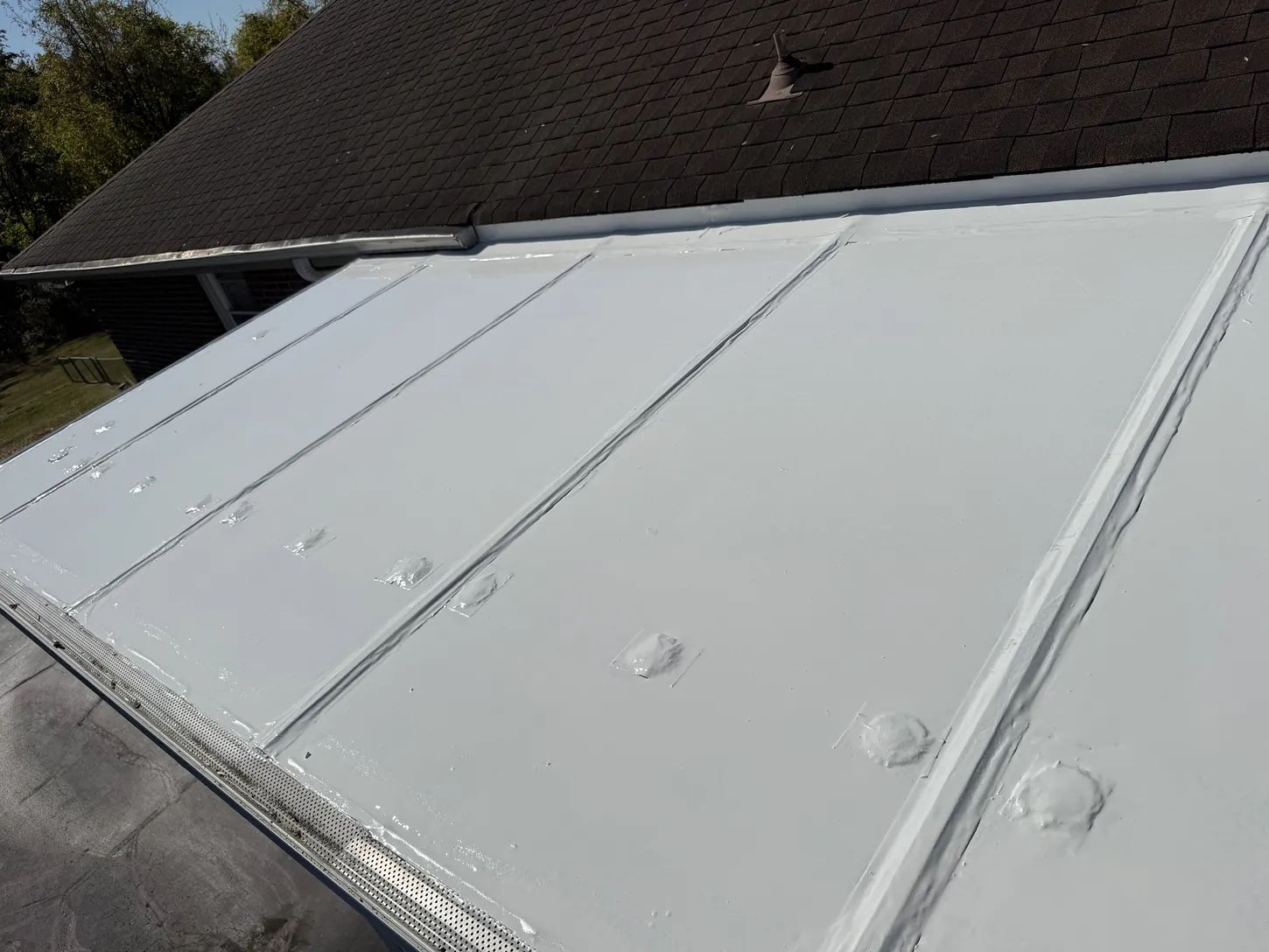 After: flat roof coated white with EPDM Coatings liquid butyl rubber